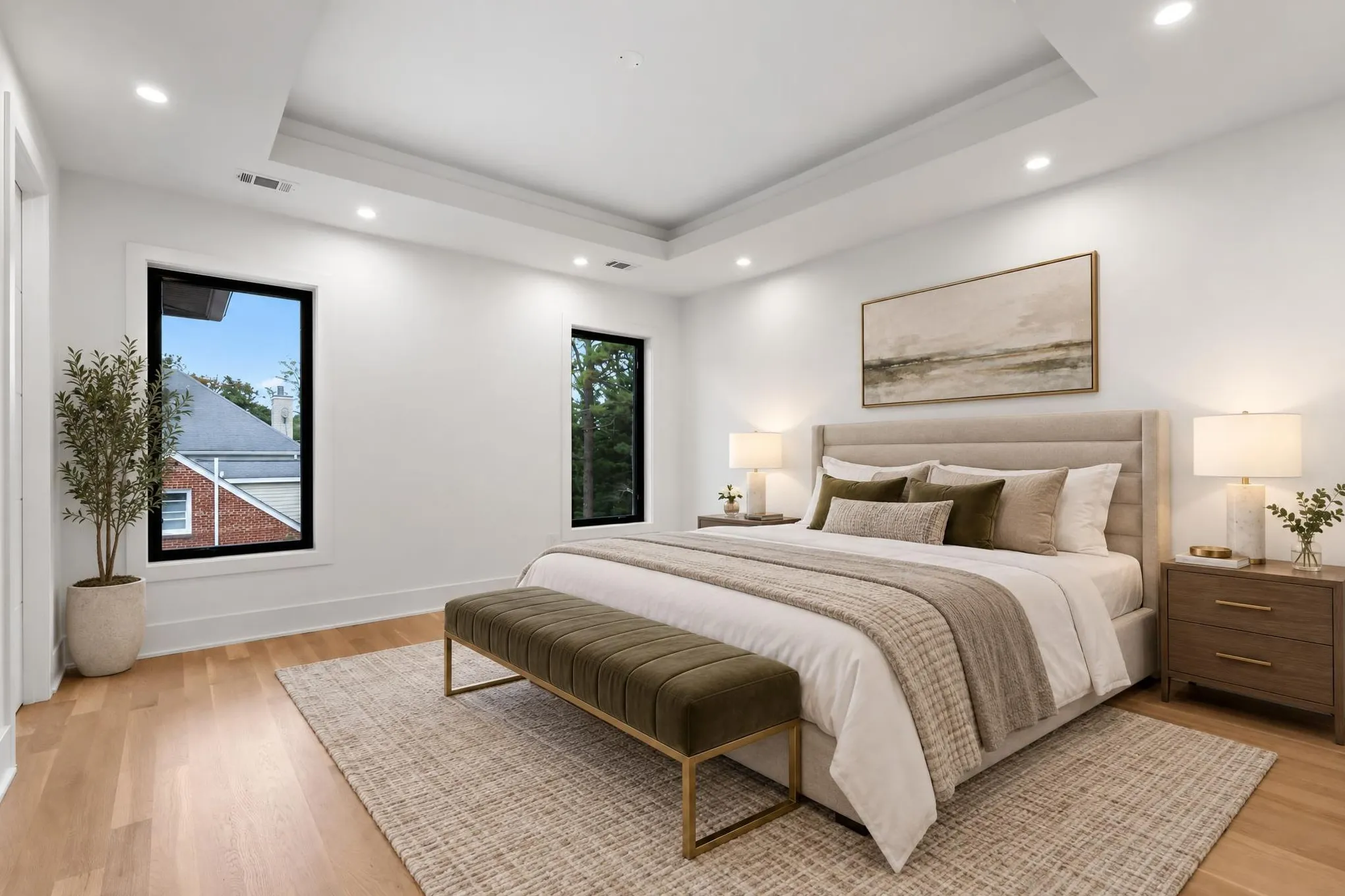 After: the same bedroom virtually staged in AI Studio with an upholstered bed, bench, rug, nightstands, lamps and wall art